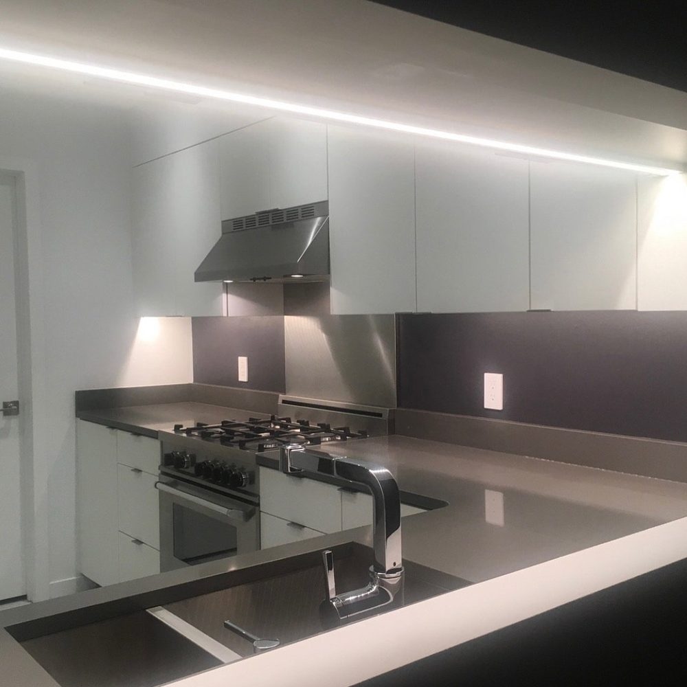 The pass-through opened across its full width, with LED lighting along the upper cabinets.