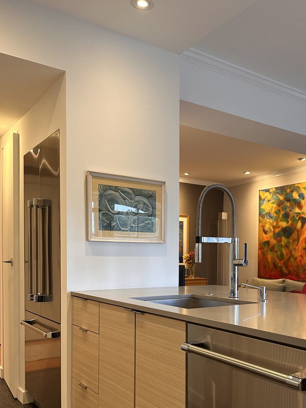 The reworked island with an undermount sink, pull-down faucet and integrated dishwasher.
